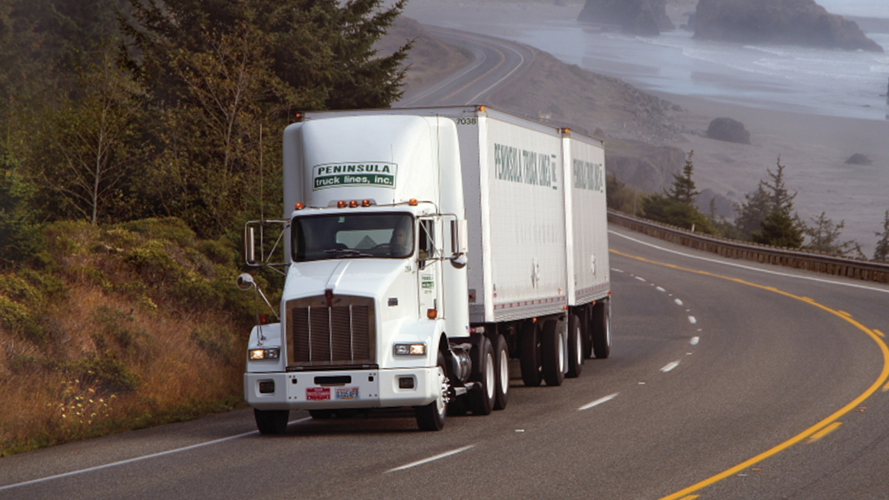 Peninsula Truck Lines imposes a  regulatory surcharge for shipments touching Oregon and Washington